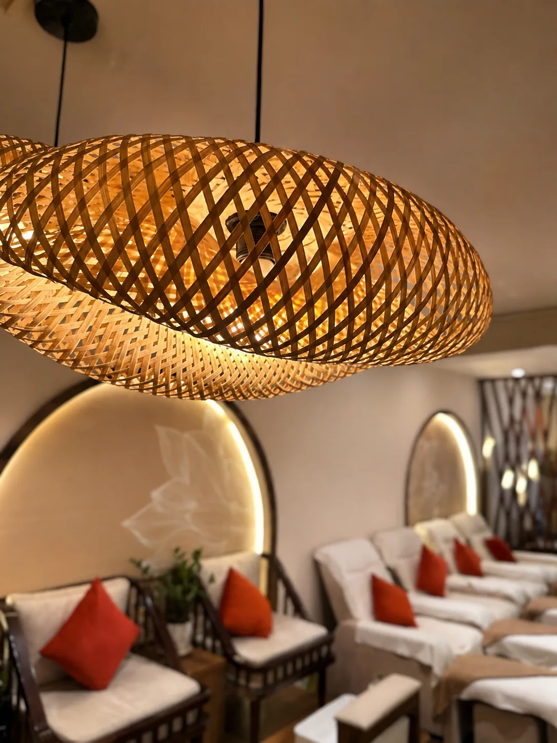 Woven bamboo lantern glowing above the reclining treatment lounge