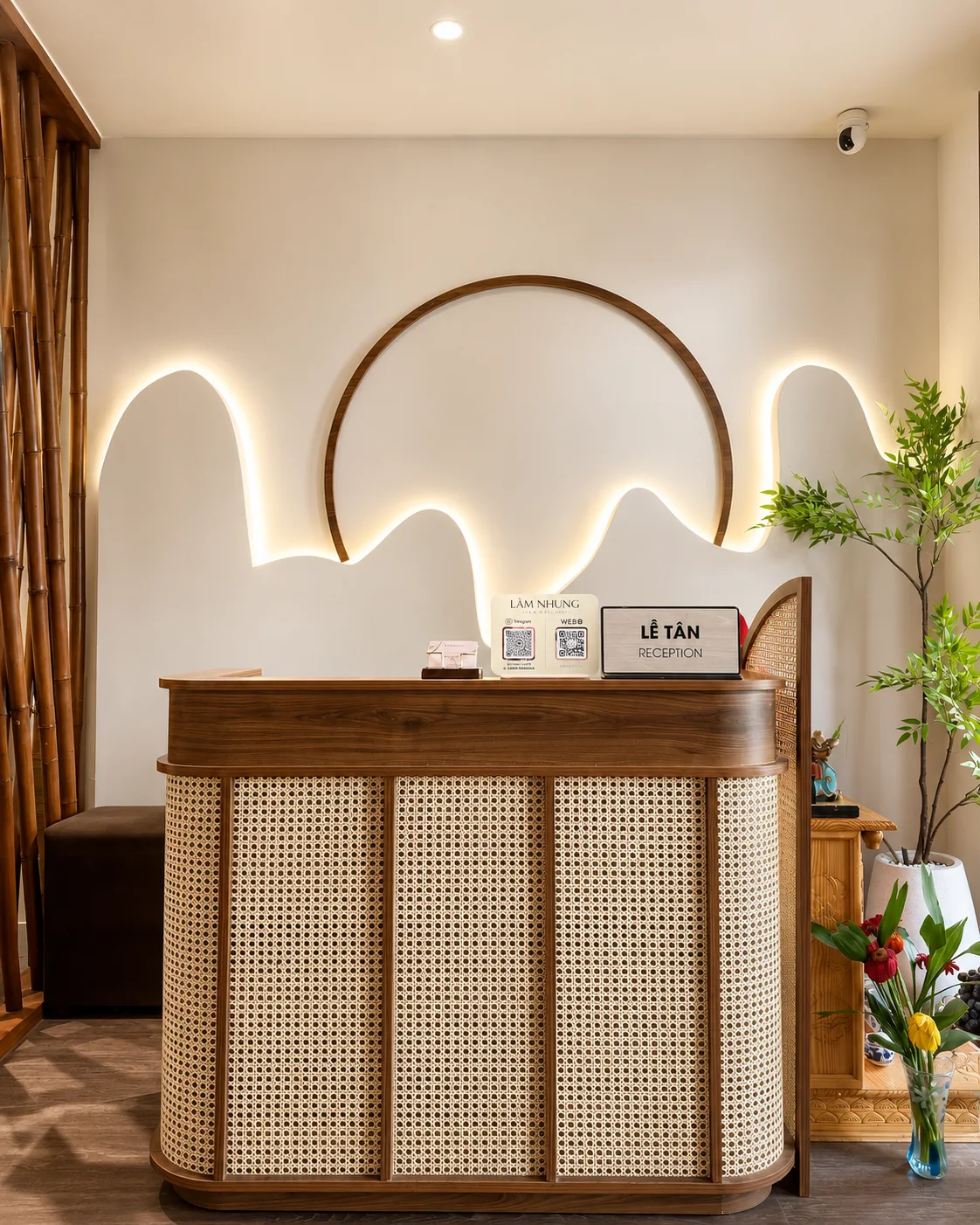 Lâm Nhung reception desk with a woven front panel and illuminated wall art